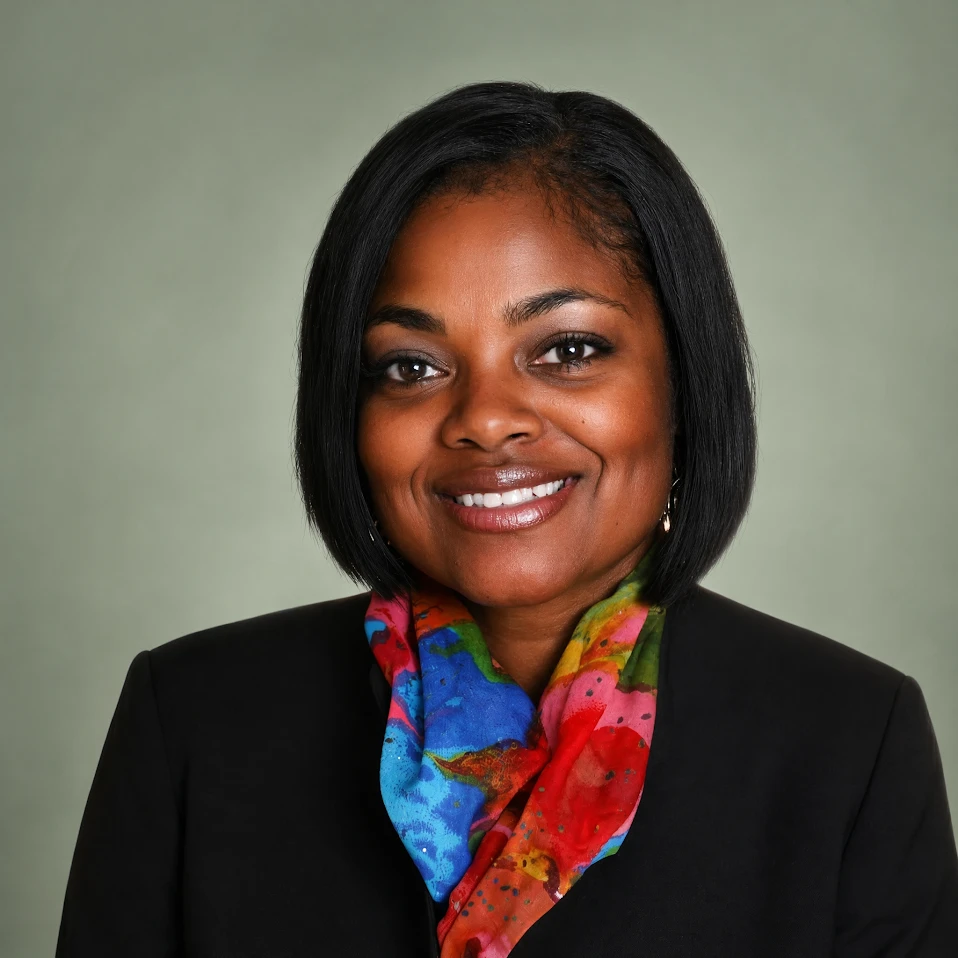 Monique Harris-Whitt, LCSW, smiling in a black blazer and a colorful scarf